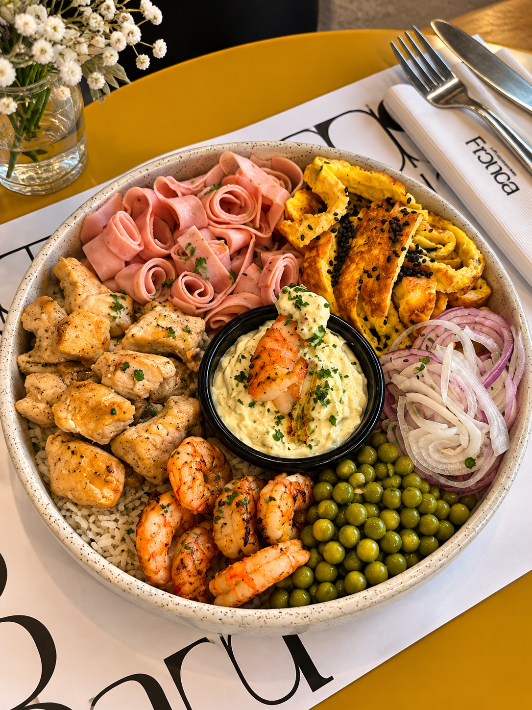 Bowl gourmet con camarones, vegetales y flores frescas